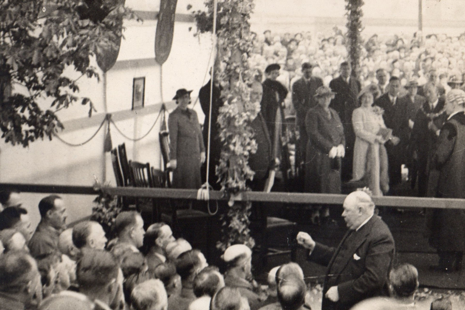Luther conducting the Orpheus for a royal visit in 1938 in a marquee at Hyde Park Corner, Colne. Queen Elizabeth the Queen Mother and King George VI can be seen directly behind him